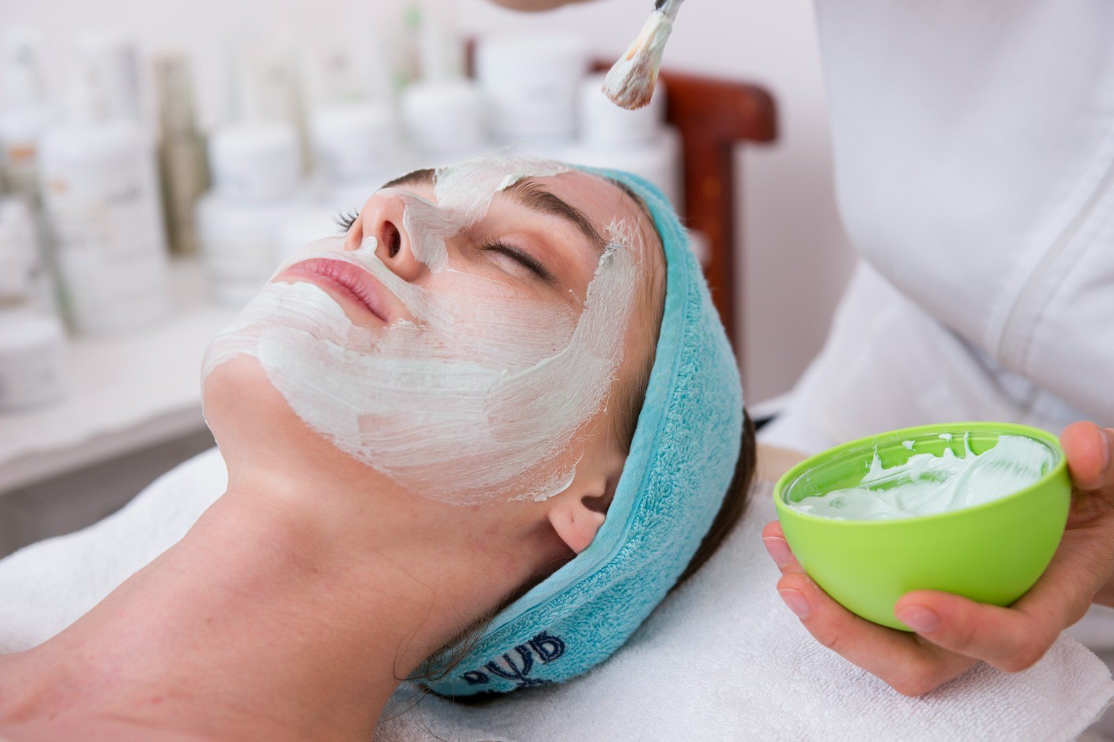 Medical Spa Profits- woman lying on blue towel with white cream on face