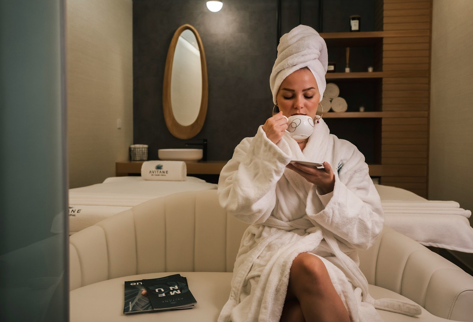 MedSpa Business Development-woman in white robe sitting on white couch